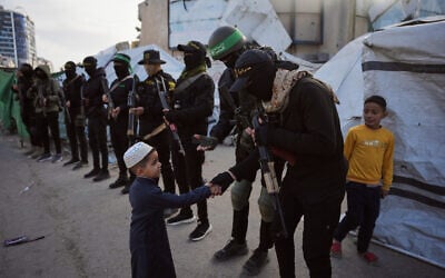 Armed members of Hamas and Islamic Jihad greet people gathering for Eid al-Fitr prayers in Gaza City, March 20, 2026. (AP/Abdel Kareem Hana) Armed members of Hamas and Islamic Jihad greet people gathering for Eid al-Fitr prayers in Gaza City, March 20, 2026. (AP/Abdel Kareem Hana)