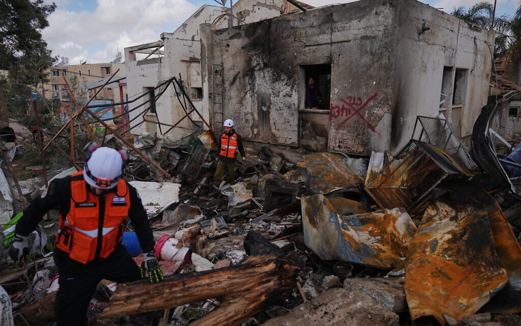 Israeli security forces survey the site that was struck by an Iranian missile in Dimona, southern Israel, Sunday, March 22, 2026. (AP/Ariel Schalit) Israeli security forces survey the site that was struck by an Iranian missile in Dimona, southern Israel, Sunday, March 22, 2026. (AP/Ariel Schalit)