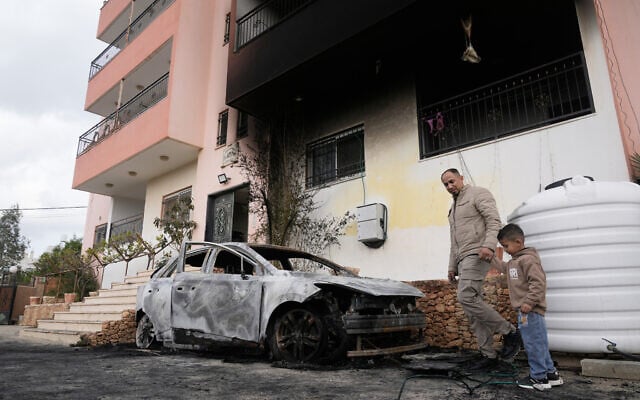 Palestinians inspect a torched vehicle following Israeli settlers' rampage through nearby Nablus-area villages on Sunday night, in West Bank village of Deir al-Hatab, Monday, March 23, 2026. (AP/Majdi Mohammed)