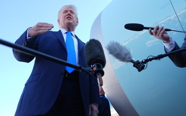 US President Donald Trump speaks with the media before boarding Air Force One, Monday, March 23, 2026, at Palm Beach International Airport in West Palm Beach, Fla. (AP Photo/Mark Schiefelbein)