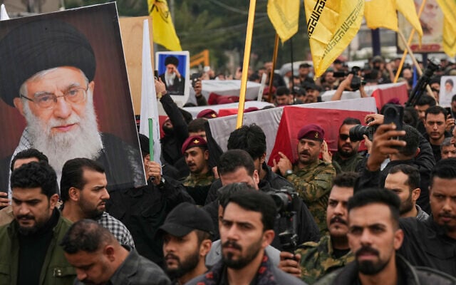 Members from the Popular Mobilization Force participate in a funeral for fighters killed a day earlier, in Baghdad, Iraq, March 24, 2026. (AP Photo/Hadi Mizban)