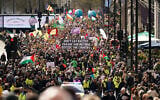People hold placards and banners during the "Together Against the Far Right" demonstration, in London, March 28, 2026. (AP Photo/Alberto Pezzali)