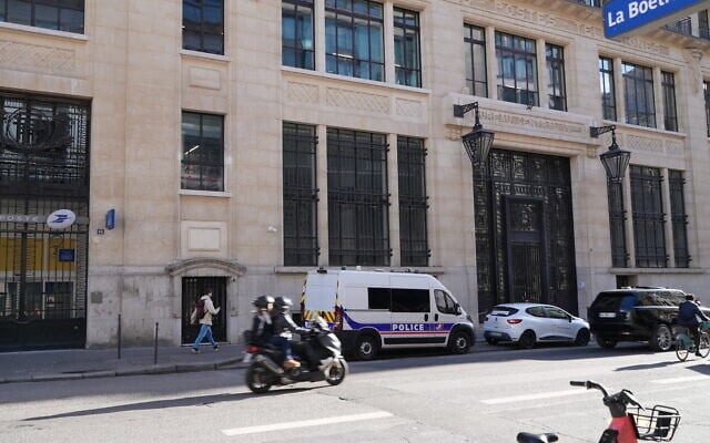 French police stand outside the Bank of America building in Paris, March 28, 2026. (AP Photo/Nicolas Garriga)