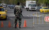 A member of the Basij paramilitary force stands at a checkpoint in Tehran, Iran, March 29, 2026. (Vahid Salemi/AP)