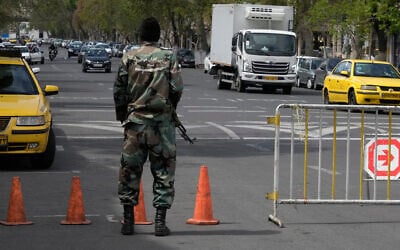 A member of the Basij paramilitary force stands at a checkpoint in Tehran, Iran, March 29, 2026. (Vahid Salemi/AP)