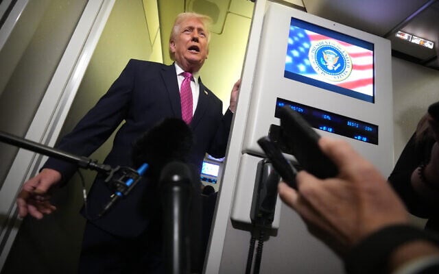 US President Donald Trump speaks to reporters aboard Air Force One en route from West Palm Beach, Florida, to Joint Base Andrews, Maryland, March 29, 2026. (AP/Mark Schiefelbein)