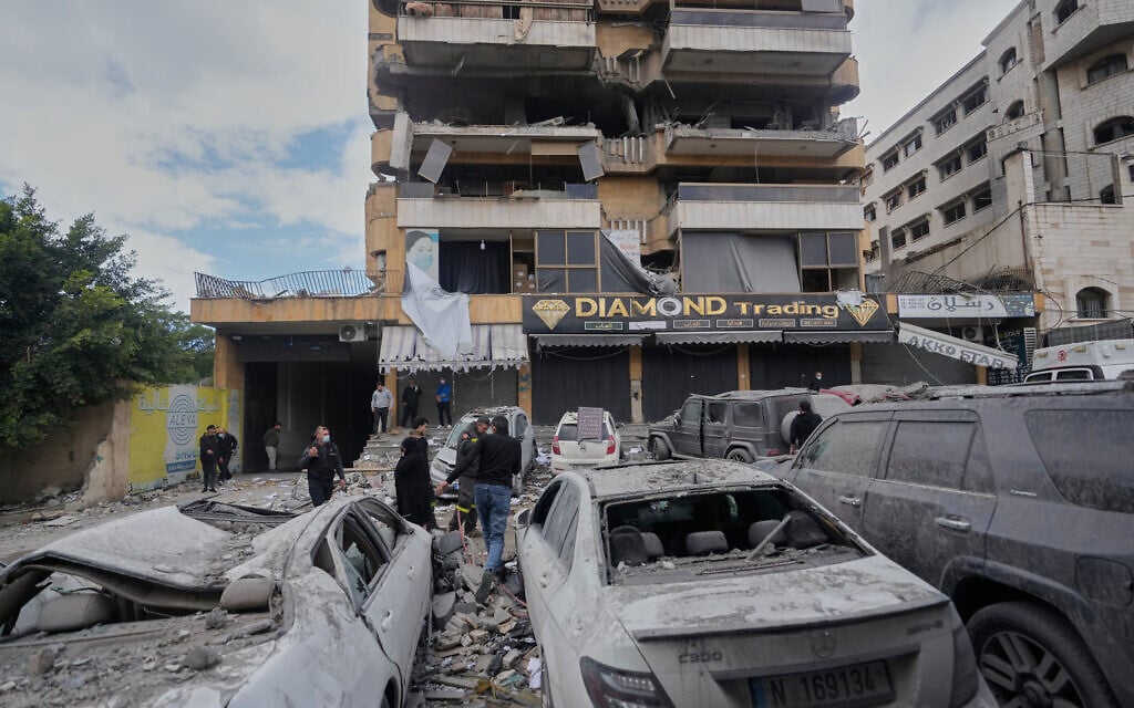 People check the site of an Israeli airstrike that hit an apartment building in Dahiyeh, Beirut's southern suburbs, Lebanon, March 30, 2026. (AP Photo/Hassan Ammar)