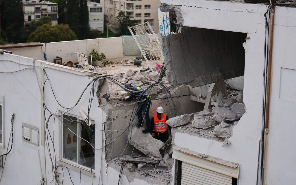 Israeli authorities inspect a damaged house following an Iranian missile strike in Haifa, March 30, 2026. (AP/Ariel Schalit)