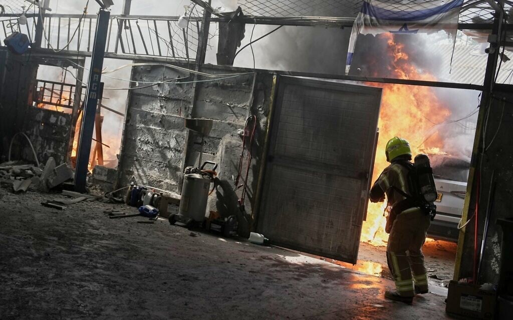 A firefighter battles flames at a damaged workshop after an Iranian missile strike in Petah Tikva, March 31, 2026. (AP Photo/Oded Balilty) A firefighter battles flames at a damaged workshop after an Iranian missile strike in Petah Tikva, March 31, 2026. (AP Photo/Oded Balilty)