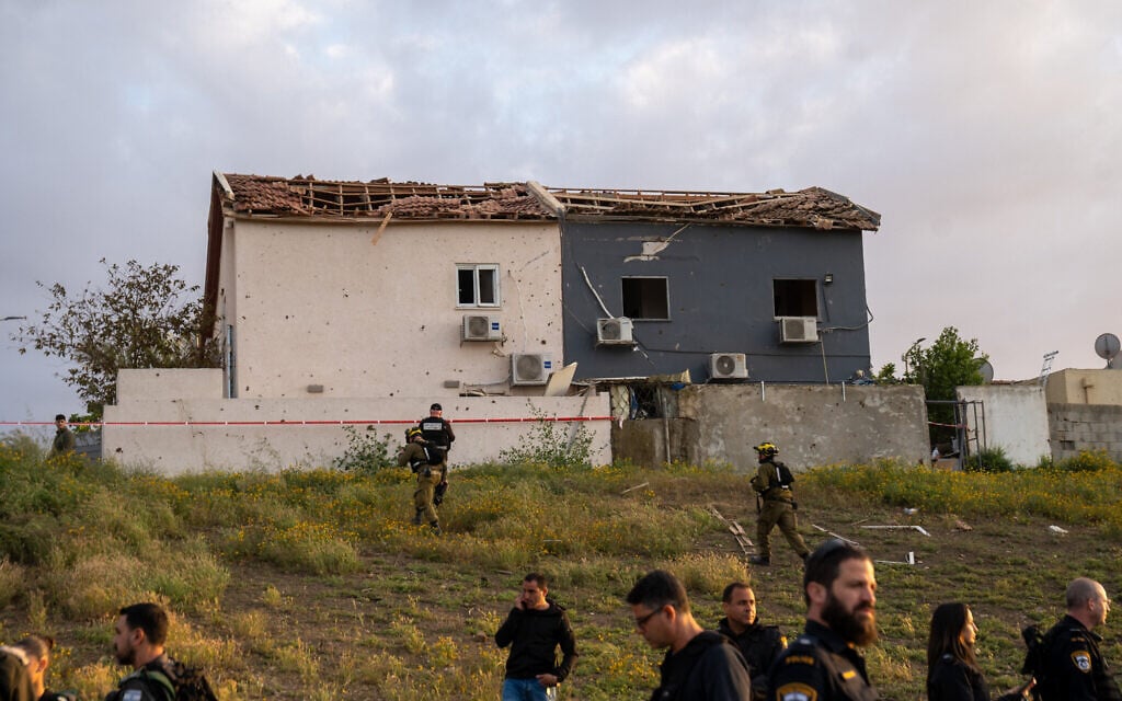Damage to nearby buildings caused by an Iranian ballistic missile that hit an open area in the southern city of Beersheba, March 29, 2026. (Emanuel Fabian/Times of Israel)