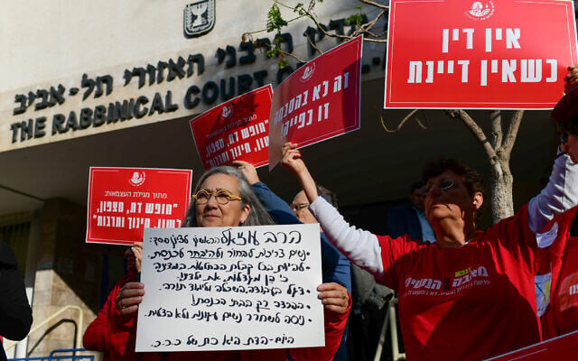 Activists protest against a bill that would give more authority to the rabbinical courts outside the Rabbinical Court of Tel Aviv, December 11, 2024. (Tomer Neuberg/Flash90) Activists protest against a bill that would give more authority to the rabbinical courts outside the Rabbinical Court of Tel Aviv, December 11, 2024. (Tomer Neuberg/Flash90)
