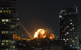 Fire and smoke rise following the impact of a ballistic missile fired from Iran in central Tel Aviv, February 28, 2026. (Chaim Goldberg/Flash90)