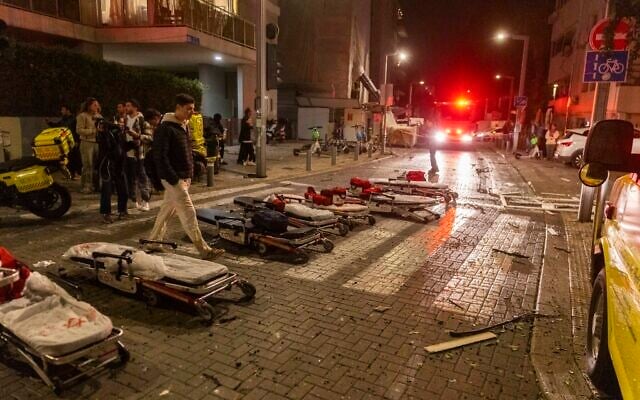 Israeli security and rescue forces at the scene where a ballistic missile fired from Iran hit in Tel Aviv, February 28, 2026. (Chaim Goldberg/Flash90)