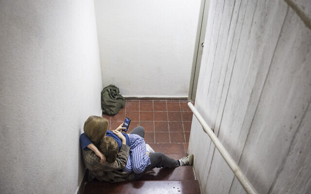 Israelis take cover in a public shelter in Tel Aviv as a siren sounds warning of incoming ballistic missiles fired from Iran toward Israel, on February 28, 2026. (Chaim Goldberg/Flash90)