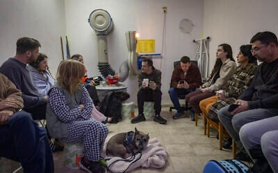 Israelis take cover in a public shelter in Tel Aviv as a siren sounds warning of incoming ballistic missiles fired from Iran toward Israel, March 1, 2026. (Chaim Goldberg/Flash90)