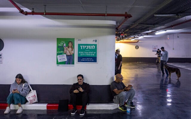 Israelis take cover at an underground parking lot in Tel Aviv as a siren sounds warning of incoming ballistic missiles fired from Iran toward Israel, March 5, 2026. (Chaim Goldberg/Flash90) Israelis take cover at an underground parking lot in Tel Aviv as a siren sounds warning of incoming ballistic missiles fired from Iran toward Israel, March 5, 2026. (Chaim Goldberg/Flash90)