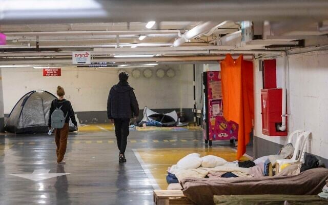 Israelis take shelter in an underground parking lot in Tel Aviv, March 6, 2026 (Chaim Goldberg/Flash90)