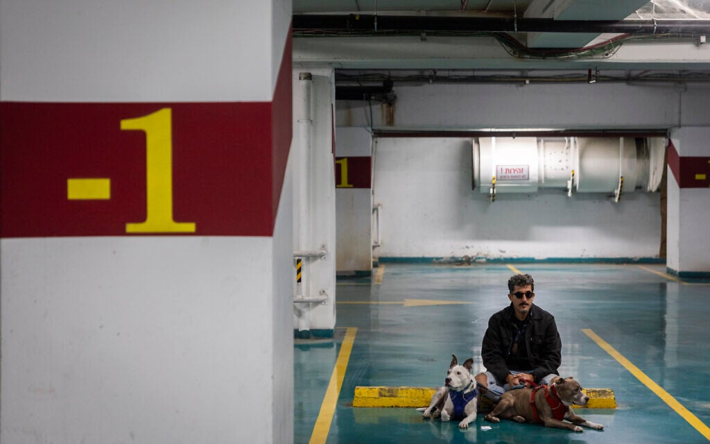 A man takes cover underground in Tel Aviv as a siren sounds warning of incoming ballistic missiles fired from Iran, March 8, 2026 (Chaim Goldberg/Flash90) A man takes cover underground in Tel Aviv as a siren sounds warning of incoming ballistic missiles fired from Iran, March 8, 2026 (Chaim Goldberg/Flash90)