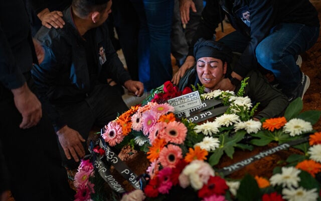 Loved ones attend the funeral of Amid Mortozov, who was killed by an Iranian projectile that struck the central city of Yehud, at a cemetery in Petah Tikva, March 11, 2026. (Flash90)