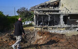 People inspect a home largely destroyed by a rocket fired by Hezbollah from Lebanon, in Haniel in central Israel, March 12, 2026. (Michael Giladi/Flash90)