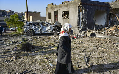 People look at the damage after a missile fired toward Israel overnight struck the Bedouin town of Zarzir, in northern Israel, March 13, 2026. (Michael Giladi/Flash90)