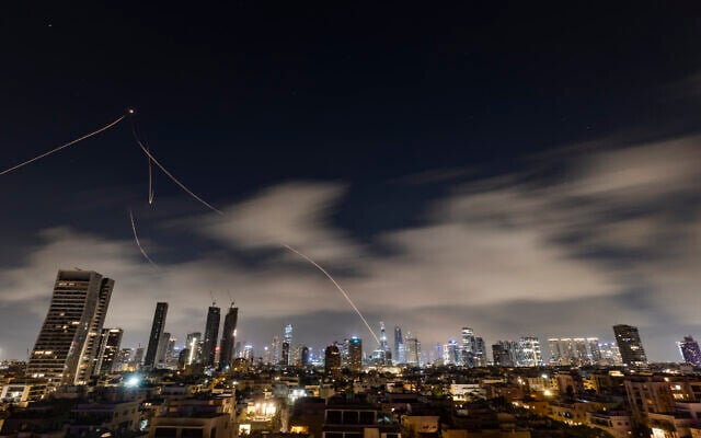 Anti-missile batteries fire interceptors toward incoming ballistic missiles launched from Iran, as seen over Tel Aviv, March 15, 2026. (Chaim Goldberg/Flash90) Anti-missile batteries fire interceptors toward incoming ballistic missiles launched from Iran, as seen over Tel Aviv, March 15, 2026. (Chaim Goldberg/Flash90)
