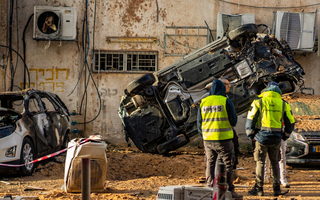 Israeli security forces check the damage after a ballistic missile attack from Iran, in Holon on March 15, 2026 (Flash90) Israeli security forces check the damage after a ballistic missile attack from Iran, in Holon on March 15, 2026 (Flash90)