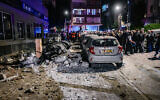 Israeli security and rescue forces inspect the damage at the scene where a missile with cluster bombs fired from Iran at Israel killed two people and caused damage in Ramat Gan, central Israel, March 18, 2026. (Avshalom Sassoni/Flash90)