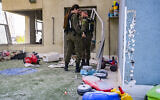 First responders work at the scene where an Iranian cluster bomb submunition hit a kindergarten in Rishon Lezion on March 21, 2026. (Avshalom Sassoni/Flash90)