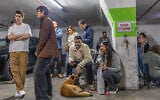 Illustrative: People take shelter amid an Iranian missile attack, in Tel Aviv, March 22, 2026. (Yossi Aloni/Flash90)