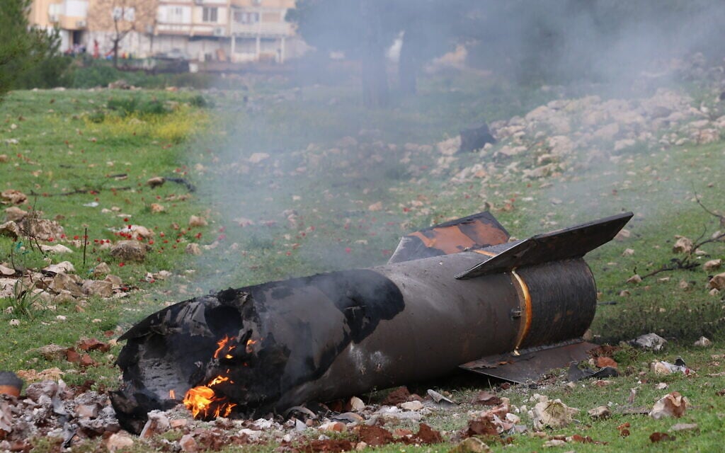 Israeli security at the scene where an Iranian missile fragment fell in an open area in the northern Israeli city of Safed, March 23, 2026. (David Cohen/Flash90)