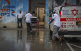 People injured in a Hezbollah missile strike on Kiryat Shmona arrive at Ziv Medical Center in Safed, northern Israel, March 23, 2026. (David Cohen/Flash90)