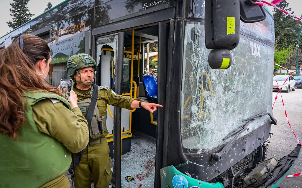 Israeli security and rescue forces at the scene where a missile fired by Hezbollah from Lebanon at Israel caused damage in the northern Israeli city of Kiryat Shmona, March 23, 2026. (Michael Giladi/Flash90)