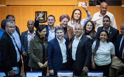 Finance Minister Bezalel Smotrich (center) and other coalition ministers and MKs celebrate the approval of the state budget in the fortified auditorium in the Knesset in Jerusalem, during the war against Iran, early on March 30, 2026. (Yonatan Sindel/Flash90)