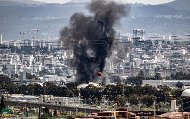Smoke rises from the oil refinery in Haifa following a missile attack fired from Iran and Lebanon at Israel, March 30, 2026. (Anthony Hershko/Flash90)