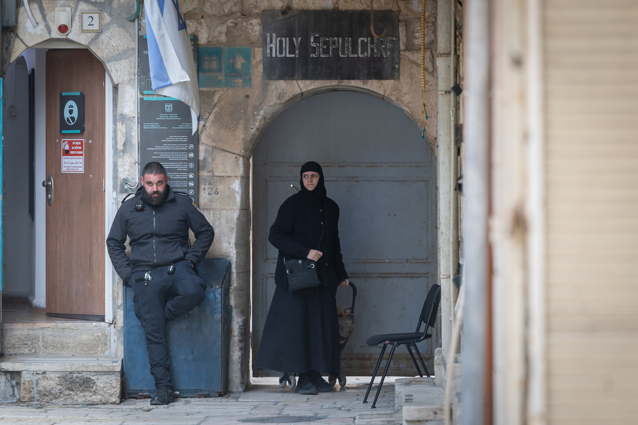 Police officer standing guard outside the Church of the Holy Sepulchre in Jerusalem during tensions between Israel and Christian communities