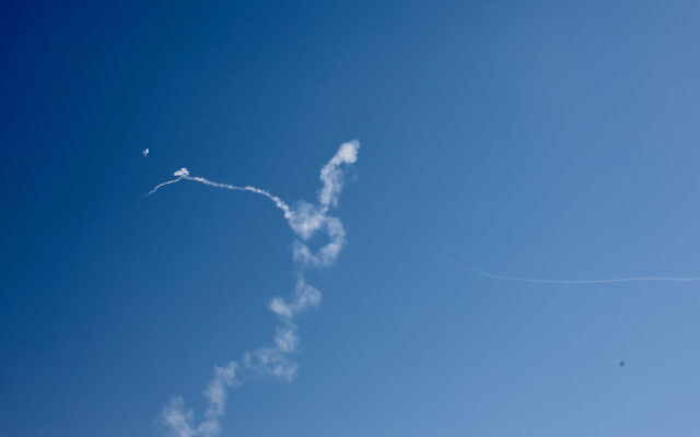 Smoke trails are seen as missiles launched from Iran toward Israel are intercepted by Israeli air defenses, March 4, 2026. (Oren Cohen/Flash90)