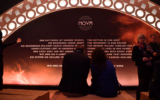 Visitors sit at the opening of the "Nova Music Festival Exhibition" in the former Tempelhof Airport in Berlin, October 5, 2025. (Paul Zinken/picture alliance via Getty Images)