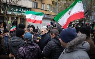 Ali Larijani (center) participates in a Quds Day anti-Israel march in Tehran on March 13, 2026, the last time he was seen alive in public. (X, used in accordance with clause 27a of the copyright law)
