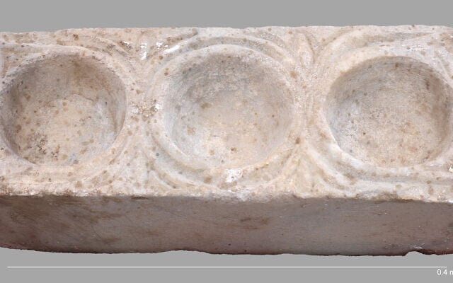 The rectangular marble block with three hemispheric cavities for oils unearthed in the southern hall of the cathedral at Hippos, east of the Sea of Galilee, in a discovery announced in March 2026. (Michael Eisenberg/University of Haifa)