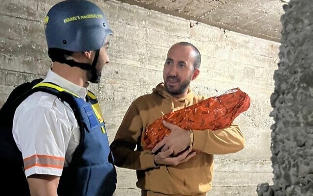 Dr. Gal Rosen, left, a Magen David Adom paramedic, with father Nikola and his baby in a shelter in Tel Aviv on March 26, 2026. (Courtesy Viri Acoca)