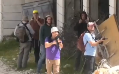 Screengrab of a social media video appearing to show Israeli settlers aim weapons and fire towards Palestinians in the village of Sa'ir, near Hebron, March 13, 2026. (X/ used in accordance with Clause 27a of the Copyright Law)