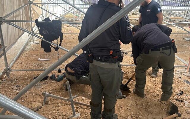 First responders at the a site just several dozen meters from the Old City of Jerusalem, and just several hundred meters from the Western Wall and the Temple Mount, where a warhead of an Iranian missile hit, in a photo cleared for publication March 1, 2026. (Israel Police)