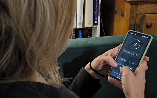 A user checks an app to see whether it's a safe time to shower. (JTA)