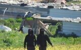 Extremist settlers threaten Palestinian Bedouin and Israeli human rights activists in Bedouin hamlets in the Mukhmas area in the West Bank, March 8, 2026. (Courtesy Torat Tzedek)
