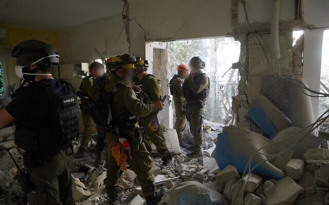 Home Front Command soldiers operate at the site of a missile impact in central Israel, March 8, 2026. (Israel Defense Forces) Home Front Command soldiers operate at the site of a missile impact in central Israel, March 8, 2026. (Israel Defense Forces)