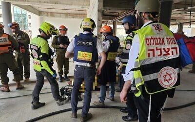 First responders at the scene of a deadly missile impact at a construction site in Yehud on March 9, 2026. (Magen David Adom)