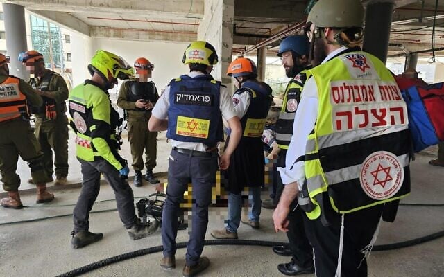 First responders at the scene of a deadly missile impact at a construction site in Yehud on March 9, 2026. (Magen David Adom) First responders at the scene of a deadly missile impact at a construction site in Yehud on March 9, 2026. (Magen David Adom)