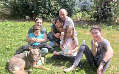 The Dymshits family at Kibbutz Be'erot Yitzhak in central Israel. From left: Lavi on Anat's lap, Michael hugging Gefen, Ofek, and Shani. (Courtesy)
