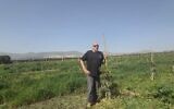Ofer Moskovitz stands in his avocado grove on March 12, 2026, overlooking the border with Lebanon. (Courtesy)